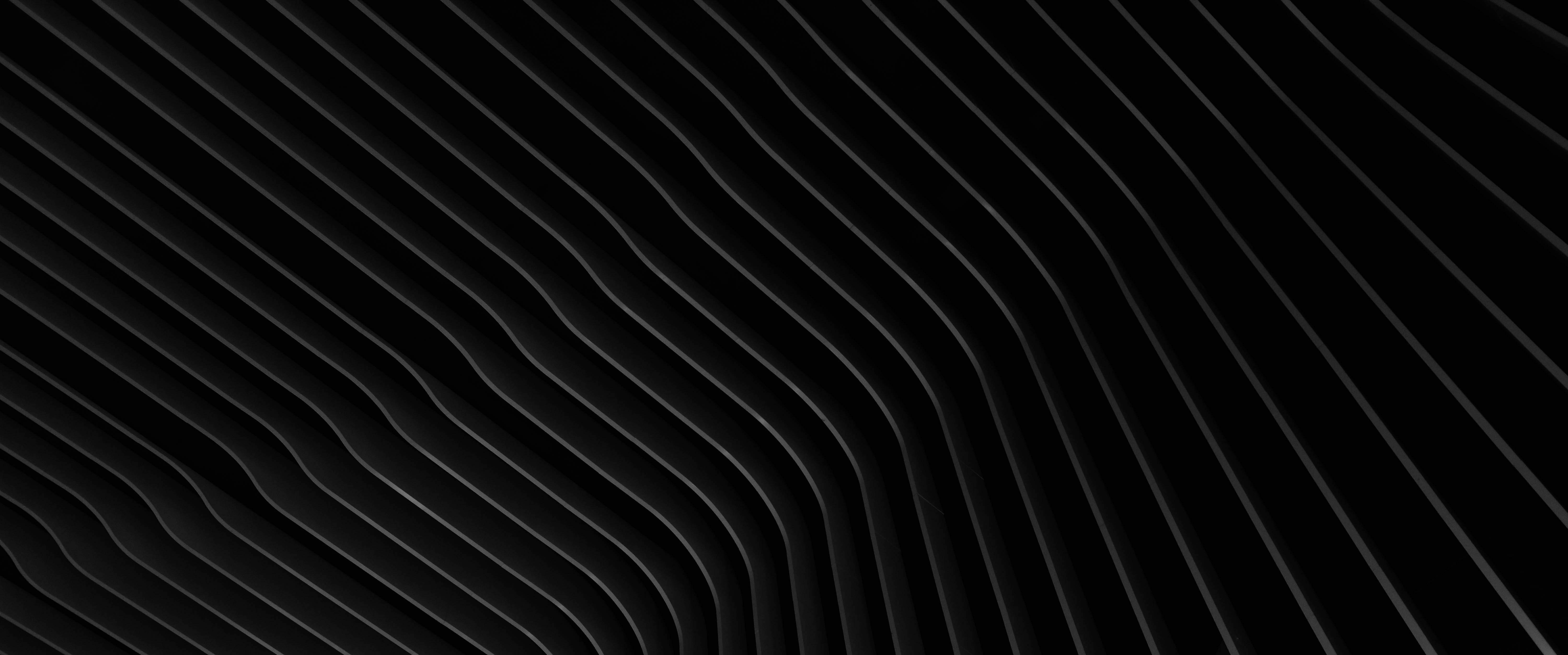 Dark, angular architectural design under artificial lights, resonating with Caldera Capital's approach to illuminating strategic pathways in complex financial transactions.